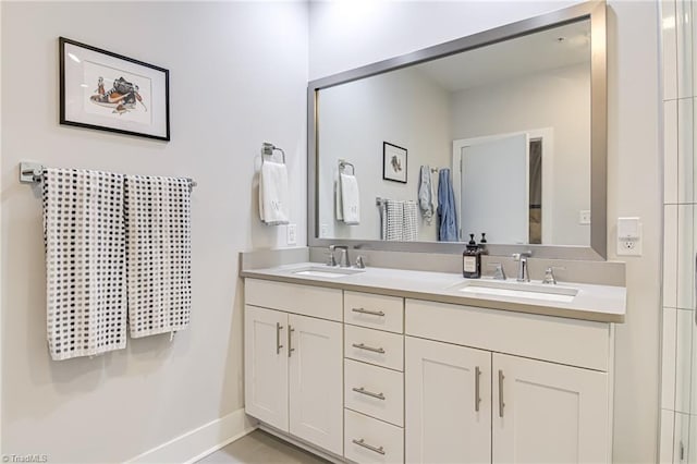 400 W 4th St Unit 401, Winston-Salem, NC 27101 - bathroom with baseboards, double vanity, and a sink