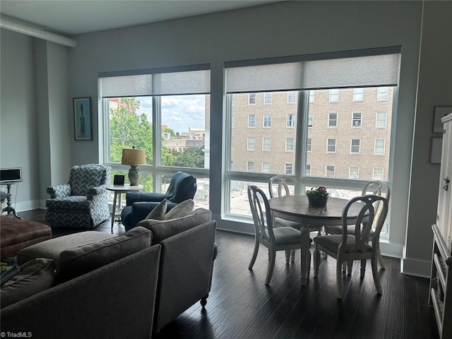 living area featuring baseboards and dark wood finished floors