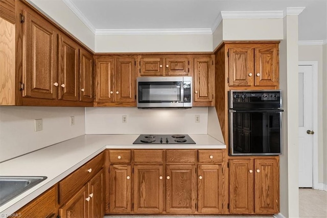 kitchen with light countertops, brown cabinets, crown molding, and black appliances