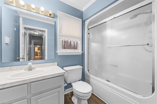 bathroom featuring enclosed tub / shower combo, toilet, wood finished floors, vanity, and crown molding