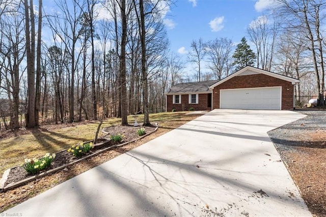 view of front facade with a garage, concrete driveway, and brick siding