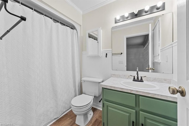 bathroom featuring vanity, wood finished floors, toilet, and crown molding