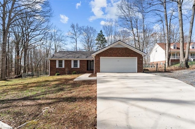 view of front facade featuring concrete driveway, brick siding, crawl space, and fence