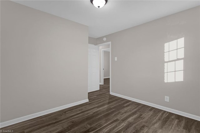 empty room with dark hardwood / wood-style floors