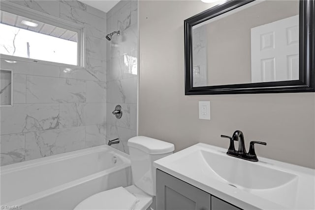 full bathroom featuring vanity, toilet, and tiled shower / bath