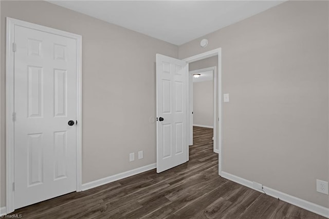 unfurnished bedroom featuring dark hardwood / wood-style floors