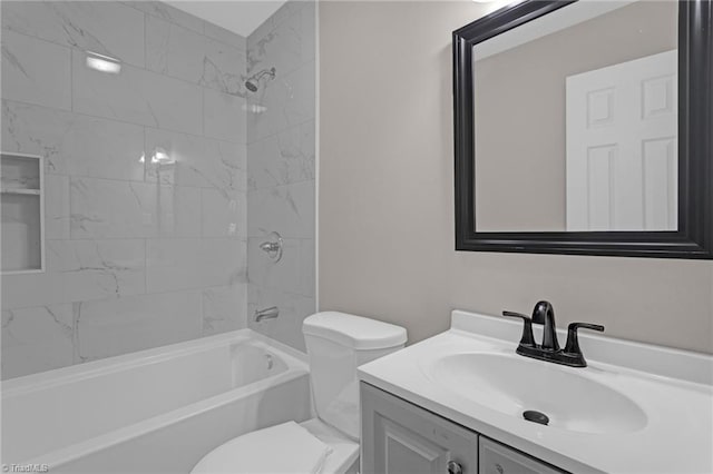 full bathroom featuring toilet, vanity, and tiled shower / bath