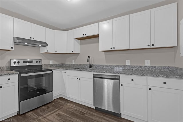 kitchen with appliances with stainless steel finishes, dark hardwood / wood-style flooring, light stone counters, sink, and white cabinetry