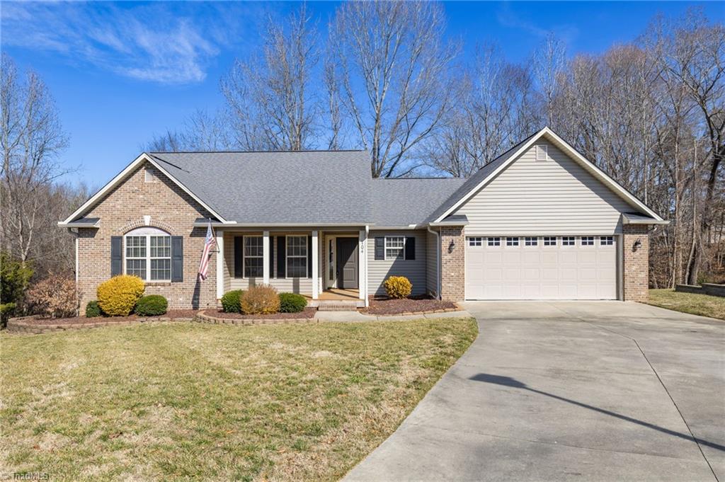 single story home with a garage and a front yard