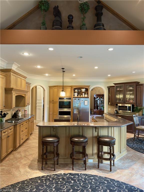 2863 Spencer Rd, Archdale, NC 27263 - kitchen with arched walkways, appliances with stainless steel finishes, ornamental molding, a kitchen breakfast bar, and recessed lighting