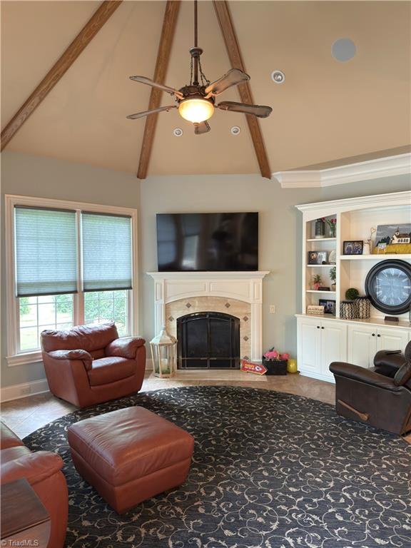 2863 Spencer Rd, Archdale, NC 27263 - living room with high vaulted ceiling, a ceiling fan, a fireplace, and beam ceiling