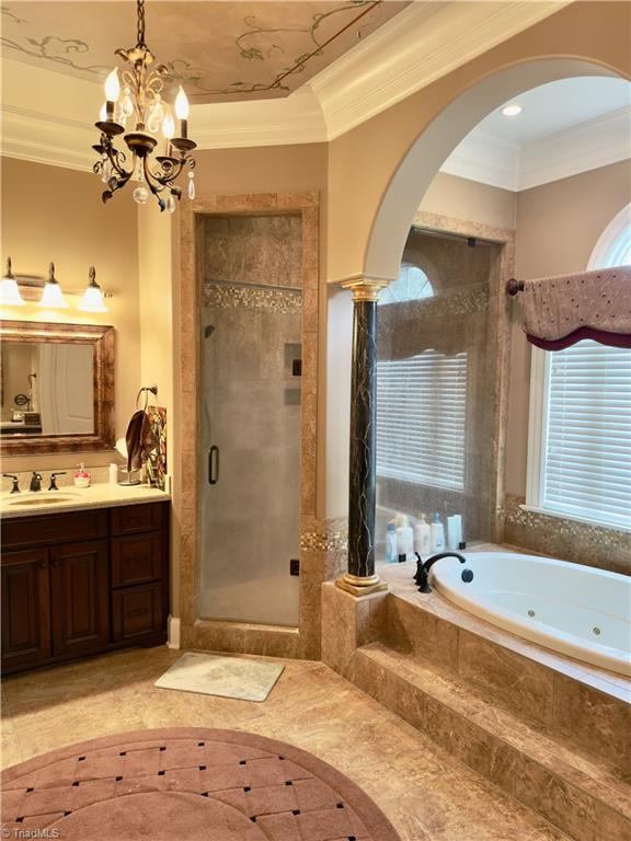 2863 Spencer Rd, Archdale, NC 27263 - bathroom with a jetted tub, vanity, crown molding, a shower stall, and a chandelier