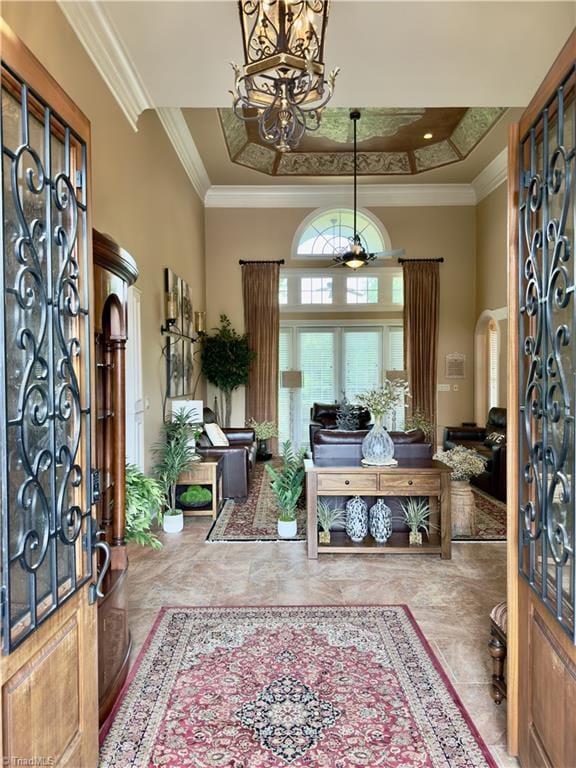 2863 Spencer Rd, Archdale, NC 27263 - foyer with a chandelier, a towering ceiling, a tray ceiling, crown molding, and arched walkways