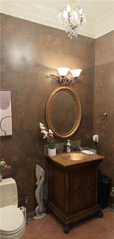 2863 Spencer Rd, Archdale, NC 27263 - half bath featuring tile patterned flooring, vanity, toilet, and a chandelier