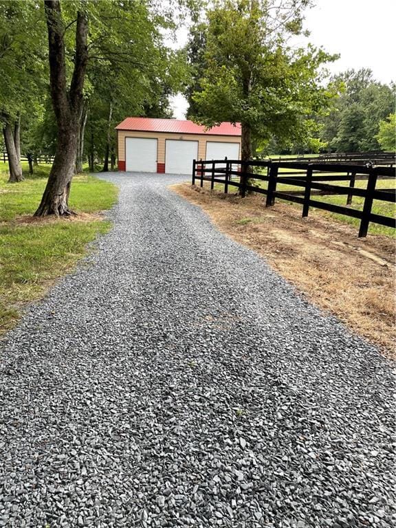 2863 Spencer Rd, Archdale, NC 27263 - view of front facade with metal roof, an outbuilding, and a detached garage