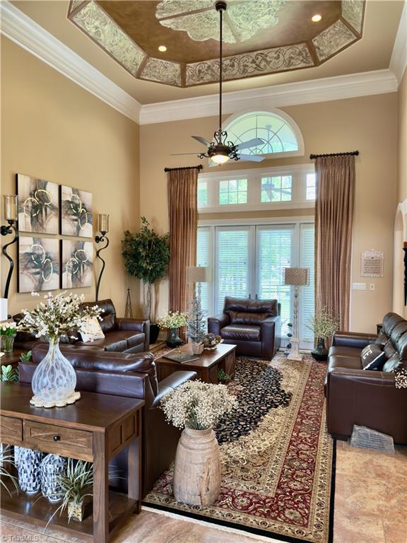 2863 Spencer Rd, Archdale, NC 27263 - tiled living area featuring a high ceiling, a tray ceiling, and crown molding