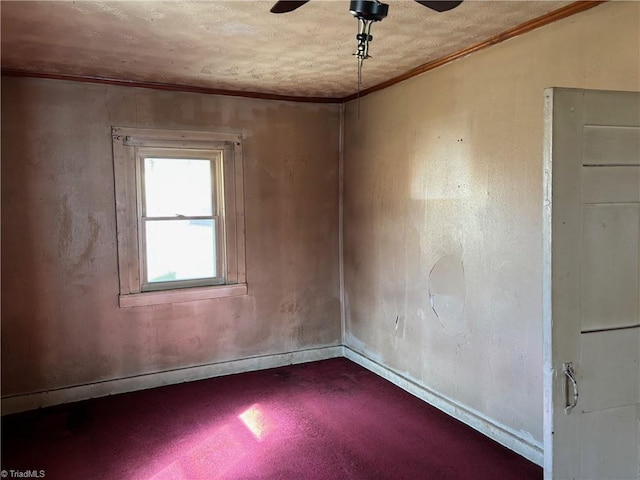 spare room with baseboards, ceiling fan, and crown molding