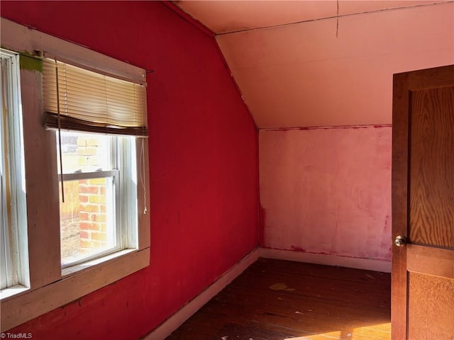 bonus room featuring baseboards, lofted ceiling, and hardwood / wood-style floors