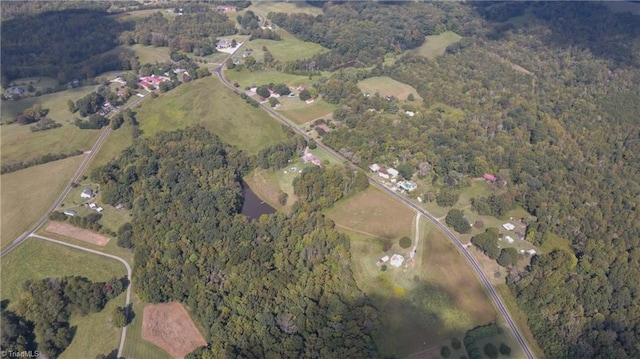 birds eye view of property featuring a forest view