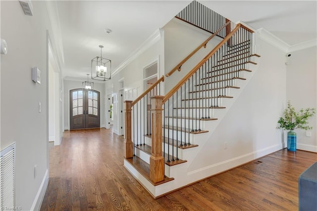 entryway featuring ornamental molding, french doors, wood finished floors, and baseboards