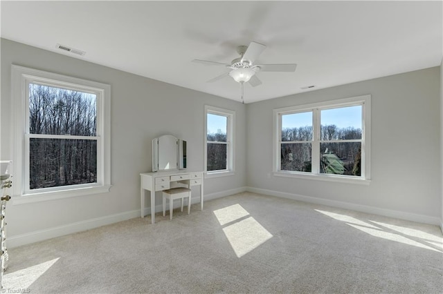 interior space with visible vents, ceiling fan, and baseboards