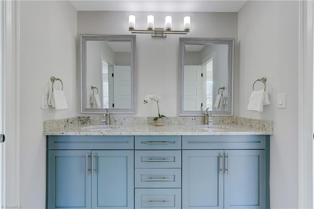 full bathroom with double vanity and a sink