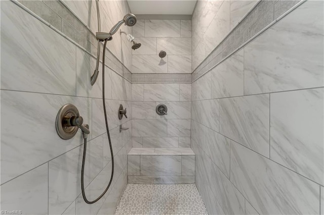 bathroom with a tile shower