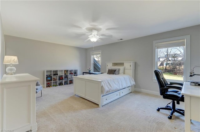 bedroom with ceiling fan, visible vents, baseboards, and light colored carpet