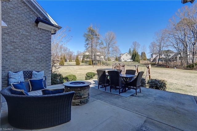 view of patio featuring outdoor dining area and a fire pit