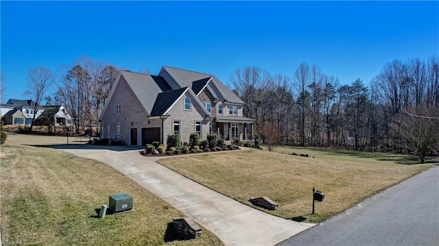 view of front of house featuring driveway, a front lawn, and an attached garage