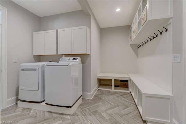 washroom featuring baseboards, recessed lighting, cabinet space, and washer and dryer