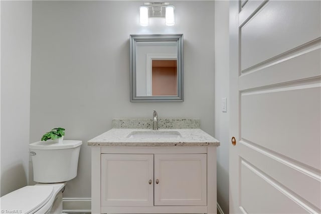 bathroom featuring toilet and vanity