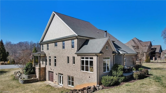 view of home's exterior featuring brick siding and a yard