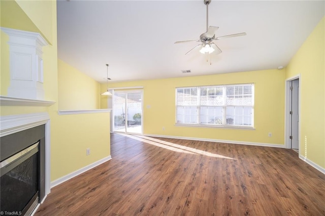 unfurnished living room featuring visible vents, baseboards, a fireplace, wood finished floors, and a ceiling fan