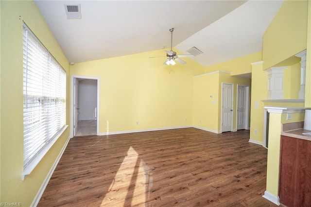 unfurnished room with visible vents, lofted ceiling, wood finished floors, and a ceiling fan