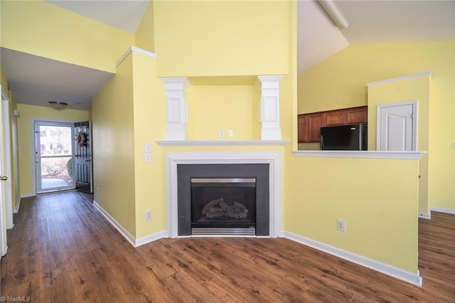 unfurnished living room with dark wood-style floors, a fireplace, high vaulted ceiling, and baseboards