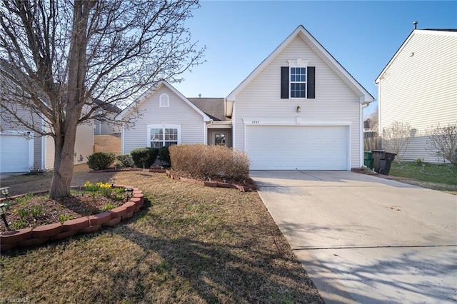 traditional home with a garage and concrete driveway