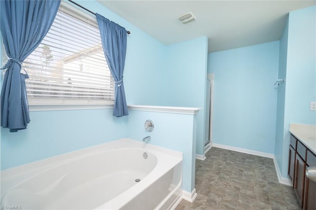 full bath featuring visible vents, a shower stall, baseboards, a bath, and vanity