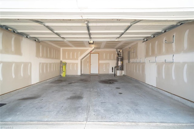 garage featuring strapped water heater and a garage door opener