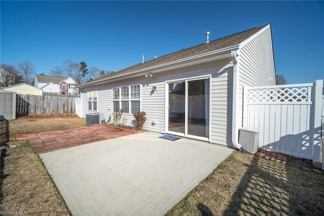 back of house with a patio, central AC, and a fenced backyard