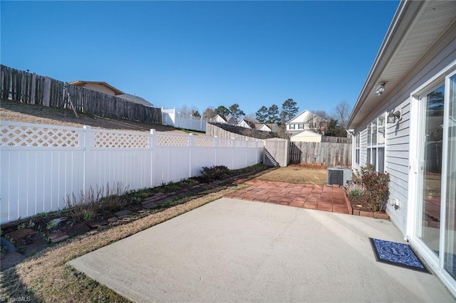 view of patio / terrace with central AC unit and a fenced backyard