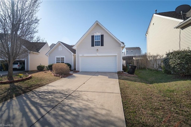 traditional-style home with driveway, an attached garage, a front lawn, and fence