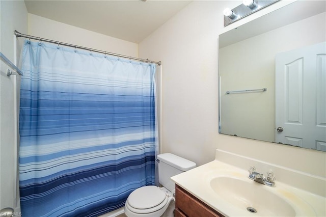 bathroom featuring a shower with shower curtain, toilet, and vanity