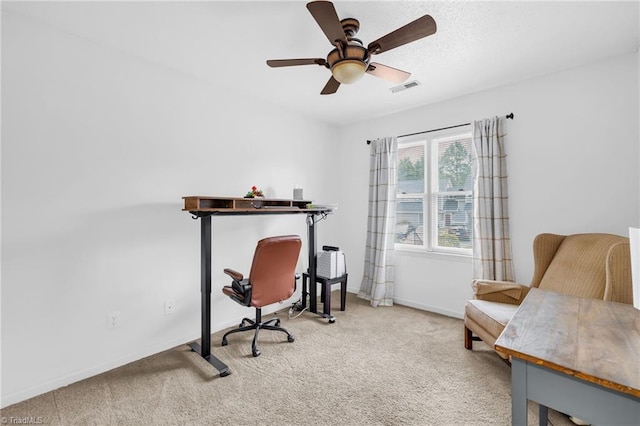 office featuring a ceiling fan, baseboards, visible vents, and carpet flooring