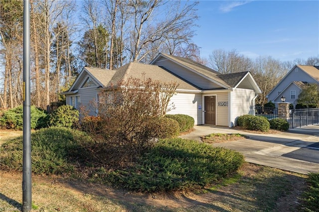 ranch-style home featuring fence