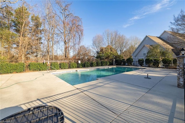 view of swimming pool featuring fence, a fenced in pool, and a patio