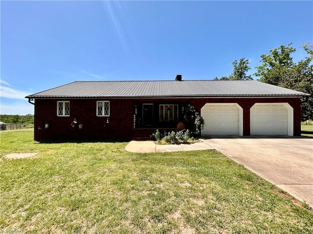 ranch-style home featuring covered porch, driveway, metal roof, a front yard, and a garage