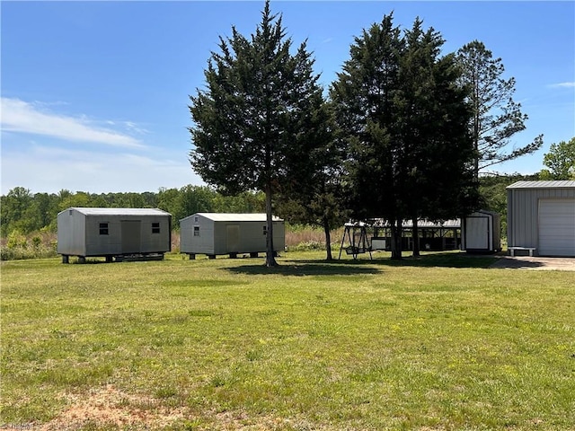 view of yard featuring a storage shed and an outbuilding