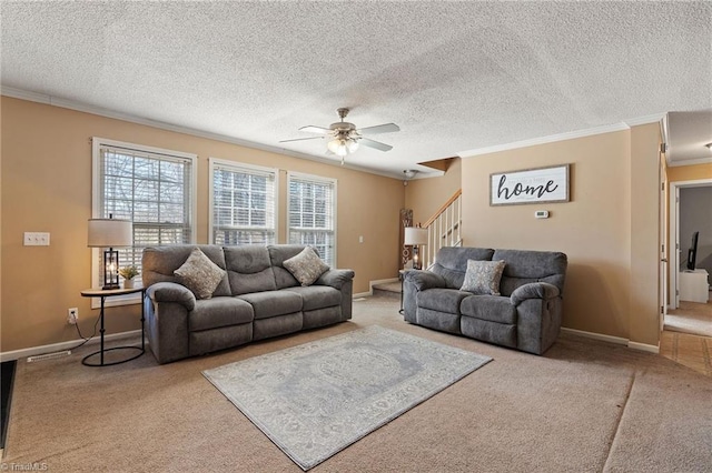 living area with stairway, baseboards, carpet flooring, and crown molding