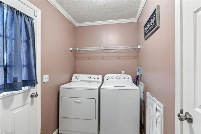 washroom with visible vents, crown molding, laundry area, a textured ceiling, and separate washer and dryer